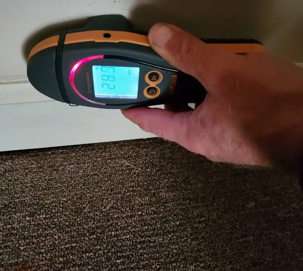 Moisture detection at baseboard during Storm Damage Restoration in Malone